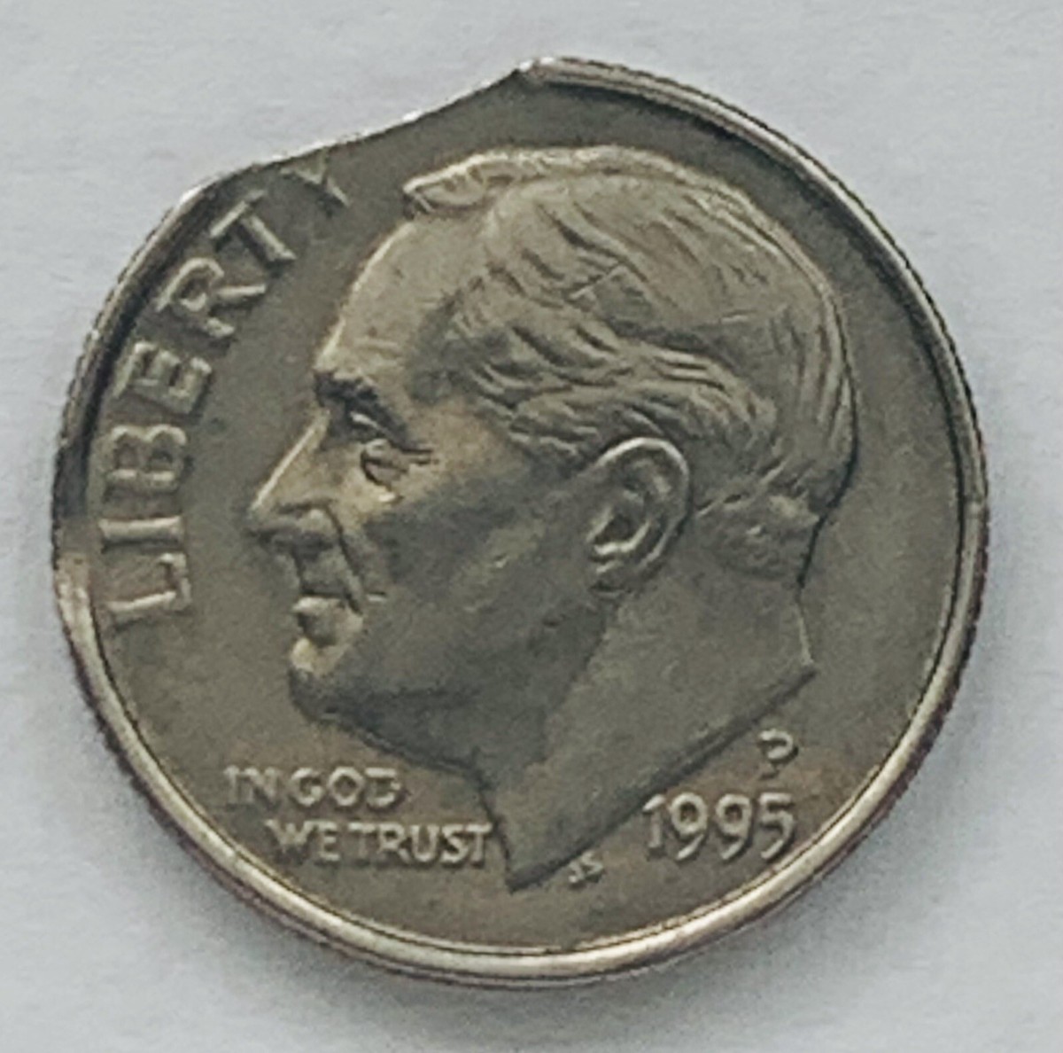 1995 Roosevelt dime clipped planchet error showing a curved section missing from the edge