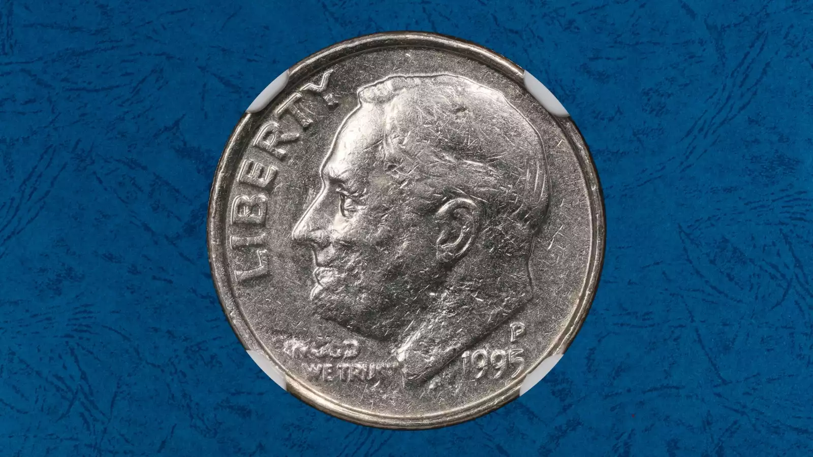 1995 Roosevelt dime strike-through error with weak design area caused by foreign material between die and planchet
